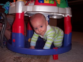 Thu Feb  2 19:32:35 2006
Andrew crawled into the bottom of his Little Einstein toy while playing in the floor with dad.  He has had a cold for a few days, runny nose and coughing...