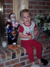 Mon 24 Dec 2007 09:46:39 PM

Andrew poses with Santa's cookie and carrots for the reindeer, right before bedtime.