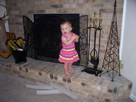 Fri 21 May 2010 03:08:46 PM

Gracie now likes to climb onto the fireplace hearth, something we never allowed Andrew to do, but...